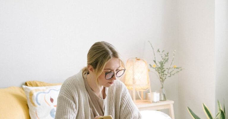 Digital Journalism - Photo of Woman Sitting on Bed While Using Black Laptop