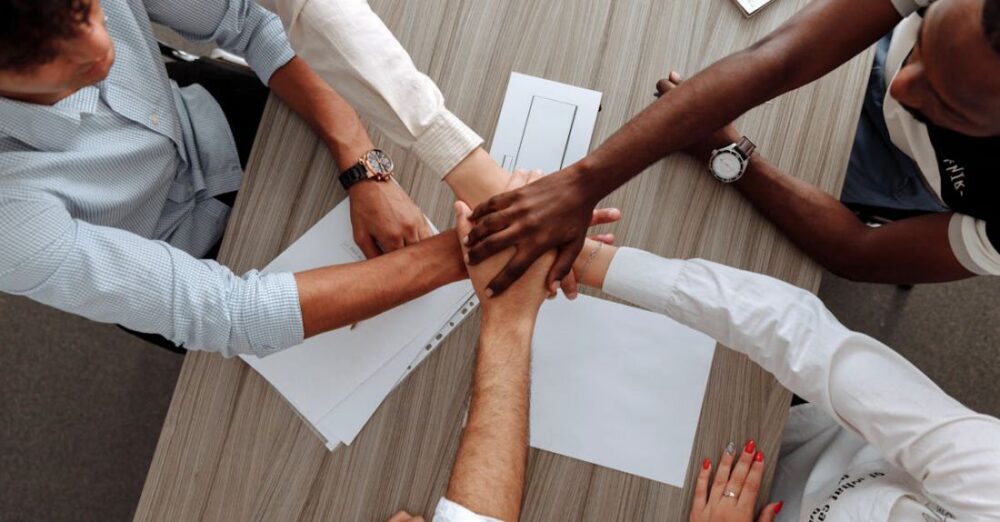 Inclusive Work Environments - Man and Woman Holding Each Other's Hands As A Team