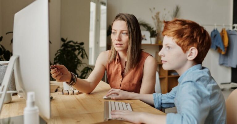 Classroom Technology - Photo Of Woman Tutoring Young Boy