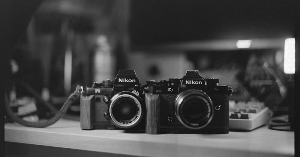 5G Technology - Two cameras sitting on a desk in black and white