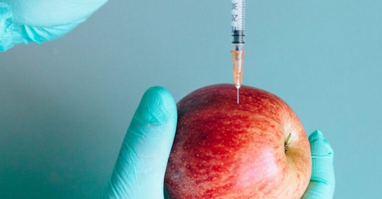 Vaccine Developments - Person Injecting a Red Apple by Using a Syringe