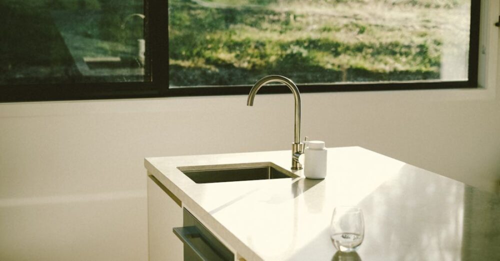 Green Initiatives - A kitchen sink with a window in the background